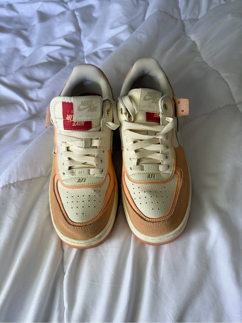 Nike Kids' Sneakers in Cream & Peach with Red Tongue Accent